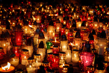 Fototapeta na wymiar Plenty of Illuminated Candle Flames in the Dark