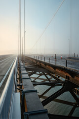 Forth Road Bridge covered in thick fog in the early morning. Scotland, United Kingdom
