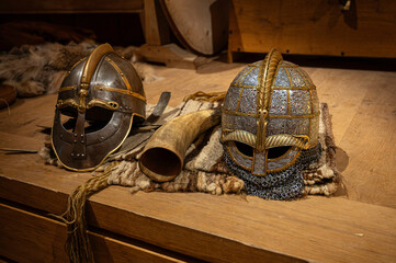 two viking helmets on a wooden table