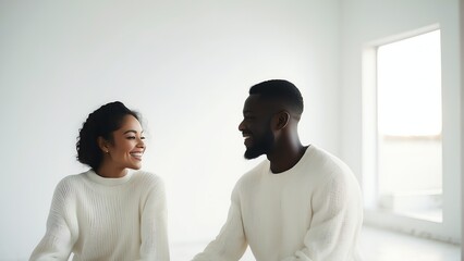 Happy young interracial couple wearing white knitted sweaters on plain white room from Generative AI