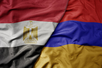 big waving national colorful flag of armenia and national flag of egypt .