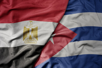 big waving national colorful flag of cuba and national flag of egypt .