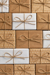 Festive background of gift boxes wrapped in kraft paper