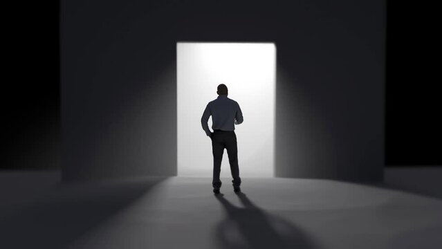 a man stands in front of the open doors towards the light