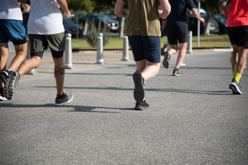 Person running on marathon racing. People exercising outdoors. Healthy lifestyle.