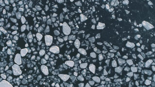 Antarctica ocean brash ice water. Zoom out top down aerial view. Flight in Antarctic melting ice glacier surface. Global Warmig Polar Nature Concept. Above Drone Footage Shot