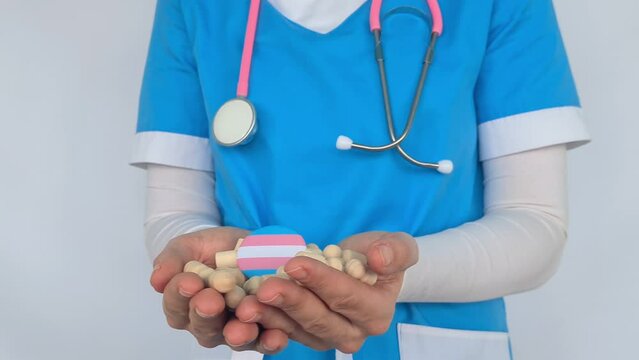 Female doctor shows LGBT pride flag in hand and hospital people figures. Medical support for LGBT community and symbol of tolerance and gender reassignment