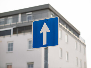 One-way street sign in Germany. The white arrow on the blue square is pointing ahead. The travel...