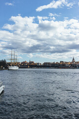 view of the town with many buildings and huge old boat on cold waters in stockholm 