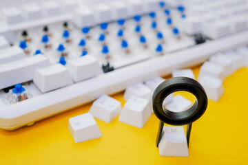 Remove mechanical keyboard keycap with tool on yellow background