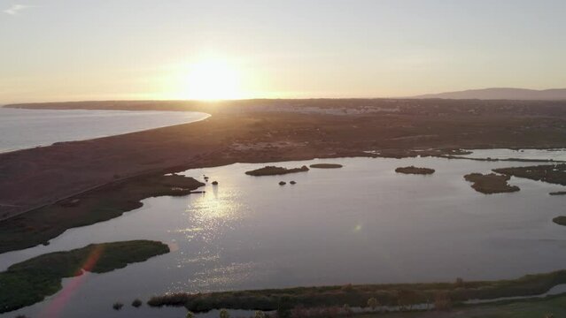Aerial panoramic sunset seascape view of Salgados beach in Albufeira, at Algarve region, a Worldwide Popular Beach and Nature Destination, in South Portugal.
