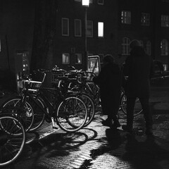 streetphotography people near bikes at nigth, black and white