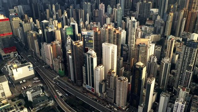 Drone, city and buildings, skyscraper and infrastructure outdoor in urban development at cbd in Hong Kong. Aerial view, cityscape and architecture in street, road or highway on landscape with clouds
