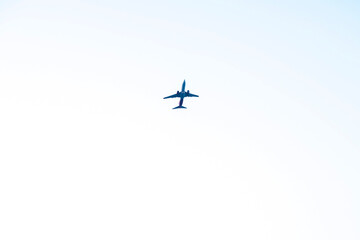 Airplane is flying against isolated white background 