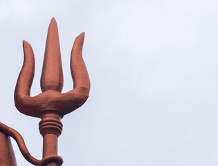 hindu god lord shiva statue trident with bright sky at morning from unique perspective