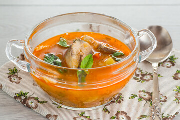 vegetable tomato soup with fish in a plate