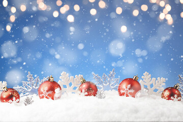 Christmas balls and snowflake with snow on color background
