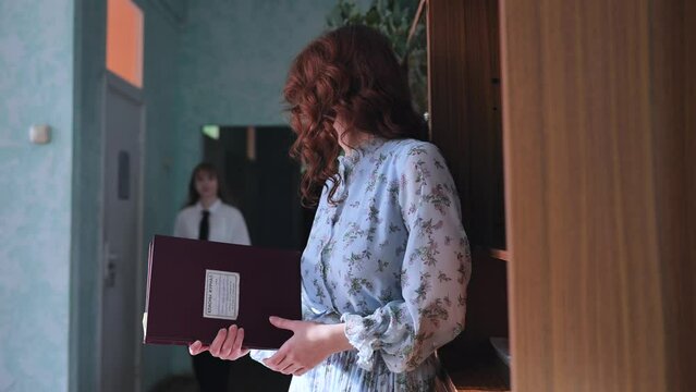 A young student peeks at the teacher's journal.