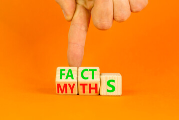 Facts or myths symbol. Concept word Myths and Facts. Beautiful orange table orange background. Businessman hand. Business and facts or myths fact myth concept. Copy space.