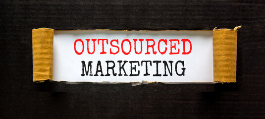 Outsourced marketing symbol. Concept words Outsourced marketing on beautiful white paper. Beautiful black paper background. Business Outsourced marketing concept. Copy space.