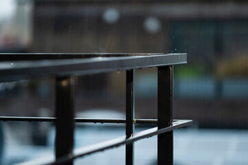 Aluminium bars of a terrace with rain splashing, Jette, Belgium