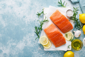 Salmon. Fresh raw salmon fish fillet with cooking ingredients, herbs and lemon, top view - obrazy, fototapety, plakaty