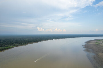 Aerial view of the Amazon river. Boat cruising in the middle