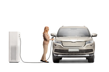 Woman with a SUV at a charging point for electric vehicles