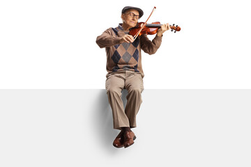 Elderly man sitting on a panel and playing a violin
