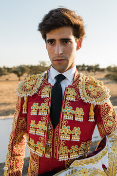 Young Hispanic bullfighter looking away