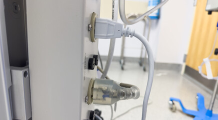 white electrical outlet on a wall with cords plugged in, emitting energy and connectivity in a modern setting