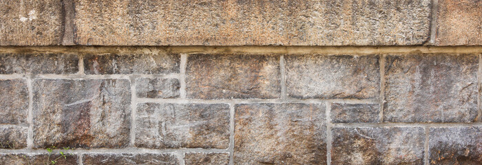 Stone texture close-up, rugged surface with natural imperfections, symbolizing durability, strength, timelessness. Ideal for architectural, nature, or background concepts