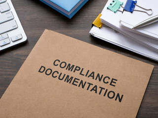 Compliance documentation on the desk.