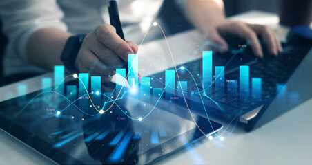 Businessman analysing economic growth graph financial data on laptop. Stock market investment. Financial and banking Technology. Business strategy and digital marketing concept.	
 - Powered by Adobe