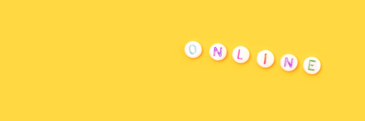 Online. Banner with quote made of beads with letters on a yellow background.