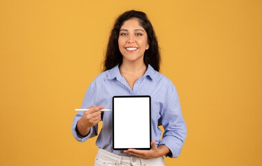 Glad latin millennial brunette woman show tablet with empty screen and pen