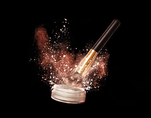 Levitation of a can of face powder with black brush. Professional cosmetics