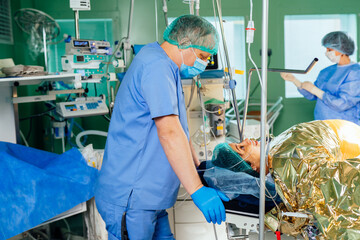 Male anesthesiologist talking with female patient after epidural anesthesia in the operating room in the maternity ward of the hospital. - obrazy, fototapety, plakaty