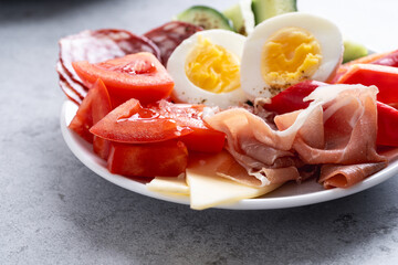 Healthy snack plate with cheese, meat, vegetables, boiled egg. Antipasto keto diet platter