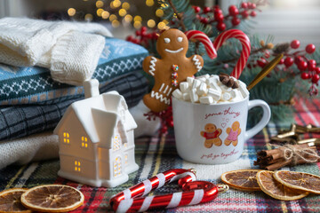 A cup of hot, aromatic cocoa with marshmallows, a calendar for 2024, a New Year's mood.