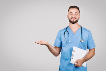 Male nurse with clipboard showcasing empty palm