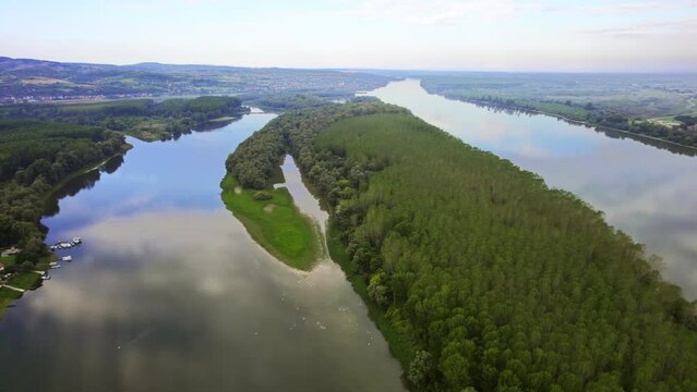 Aerial footage of river Danube and a wooded island in the middle of it