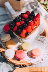 Bright and Colorful Berry Tart and Macaron Desserts at a Picnic Celebration