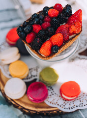 Bright and Colorful Berry Tart and Macaron Desserts at a Picnic Celebration