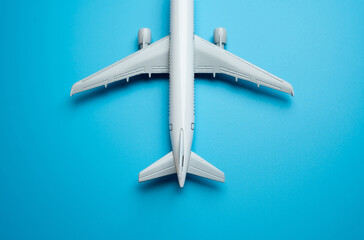 Airline plane top view on blue background. Passenger transportation. Business and tourism. Airline. World communication and commercial flights. Place for text. Arrival and departure. Airplane arrival.