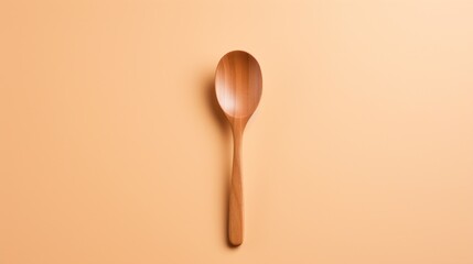  a wooden spoon sitting on top of a peach colored table next to a wooden spoon with a wooden spoon rest on top of a peach colored table next to a peach colored wall.