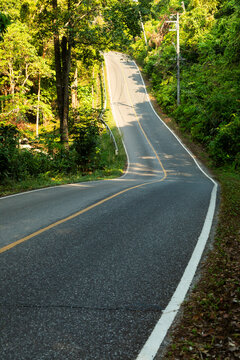 A lonely road through the jungle on the island of Koh Chang in the Gulf of Thailand
