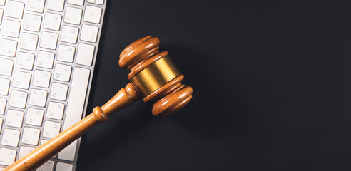 Judge gavel with computer keyboard