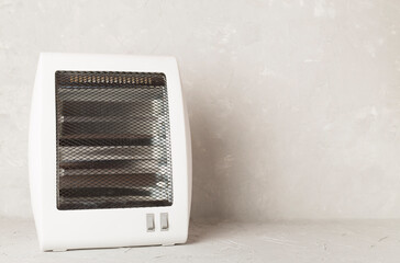Portable electric halogen heater on table