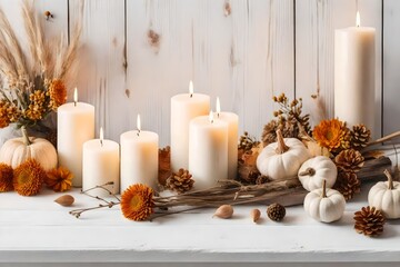 Fototapeta na wymiar bombs with dry flowers and lit candles in Scandinavian Style. Fall decoration in white beige colors on white rustic wooden background. Autumnal still life.